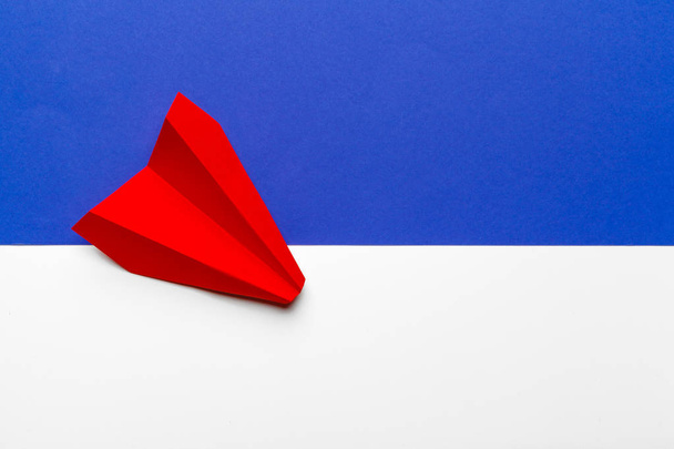 Red paper origami plane. Transportation and business concept - Photo, image