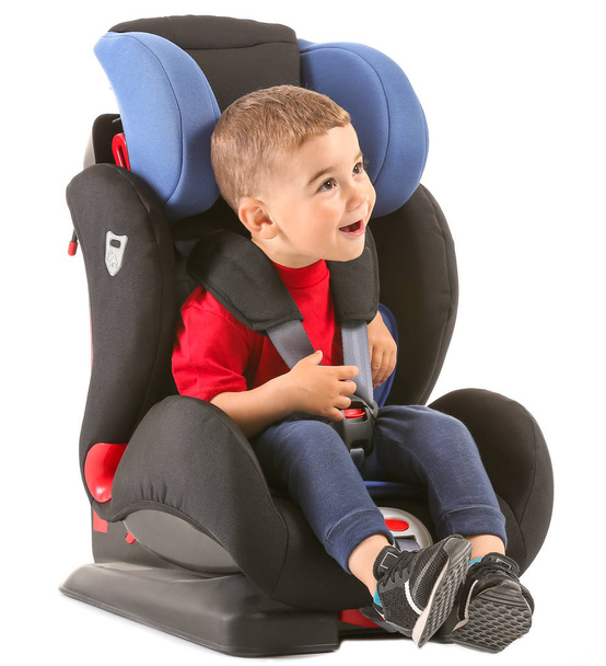 Little boy buckled in car seat on white background - Photo, Image
