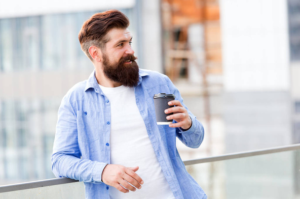 Coffee completes me. Make yourself useful. Man drink take away coffee. Bearded man relax outdoors. Coffee break concept. Caffeine addicted. Morning coffee. Mature hipster enjoy hot beverage - Photo, Image