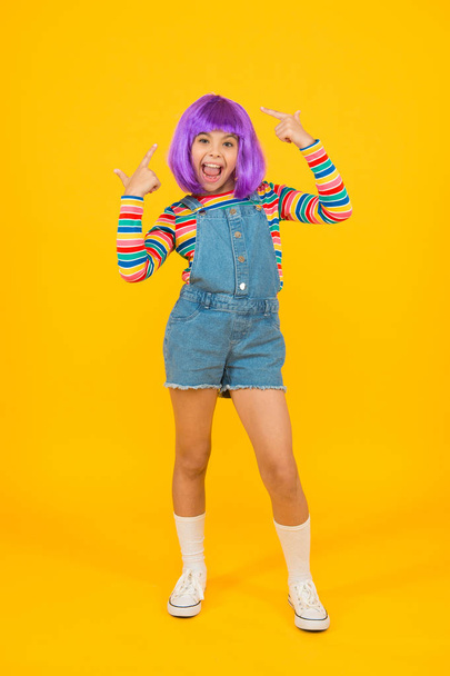 Cosplay character concept. Culture hobby and entertainment. Happy childhood. Anime fan. Cosplay kids party. Child cute cosplayer. Cosplay outfit. Otaku girl in wig smiling on yellow background - Foto, Bild