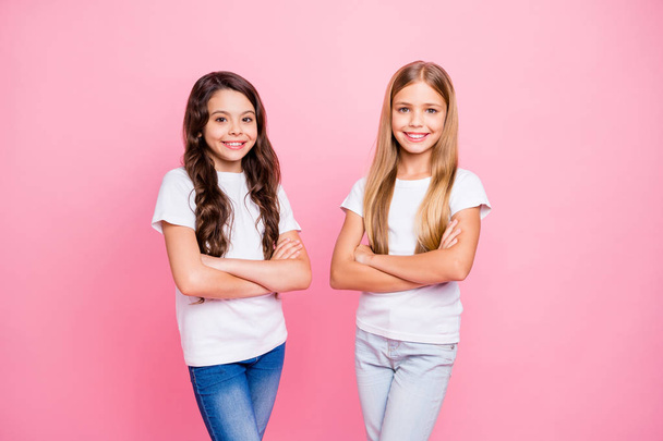 Photo of successful little children girls being photographed over pink background wearing jeans denim with arms crossed - Fotoğraf, Görsel