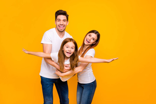 Photo of three family members spending leisure time resting together wear casual outfit isolated yellow background - Zdjęcie, obraz
