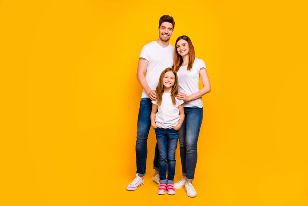 Full length photo of family spending leisure time together wear casual outfit isolated yellow background - Foto, imagen