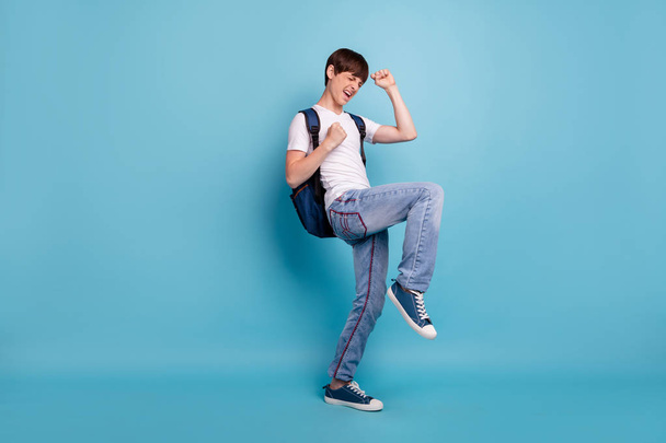 Full length body size photo of dancing rejoicing overjoyed cheerful guy having won olympiad games at math at school while isolated with blue background - Foto, afbeelding