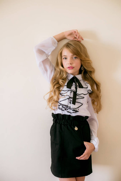 Cute girl with long blond curly hair in school fashion clothes. School fashion in vintage elite style. - Fotoğraf, Görsel