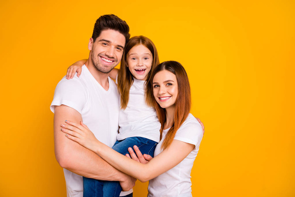 Portrait of three nice attractive charming cute winsome lovely cheerful cheery person spending weekend cuddling isolated over bright vivid shine yellow background - Fotografie, Obrázek