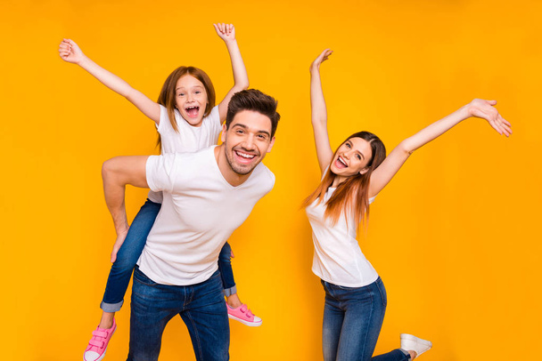 Portrait of three nice attractive charming cute lovely stylish trendy cheerful cheery carefree playful glad person having fun time dancing isolated over bright vivid shine yellow background - Fotografie, Obrázek