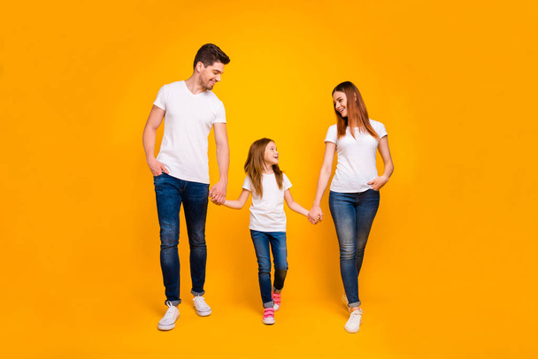 Full length body size view of three nice attractive lovely stylish trendy cheerful cheery carefree person holding hands spending free time strolling isolated on bright vivid shine yellow background - Foto, Bild