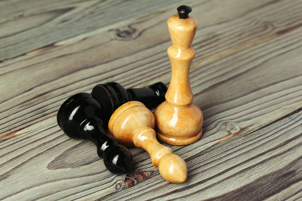 Chess figures on dark wooden background side view copy space - Фото, изображение
