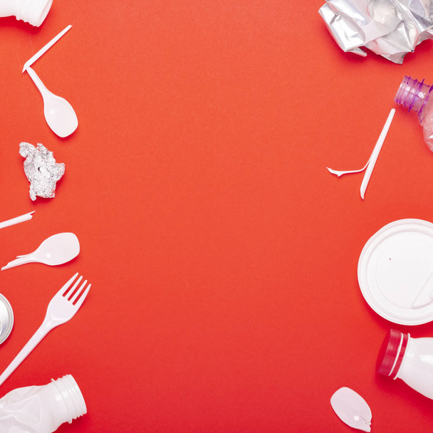Plastic waste collection on a red background. Concept stop plastic recycling garbage. Flat lay, top view - Photo, Image