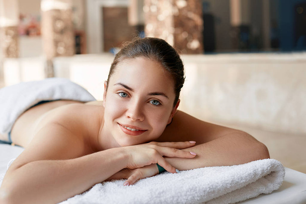 Beautiful woman in spa salon having body relaxing massage. Body care. Spa. Woman having massage in the spa salon - Photo, Image
