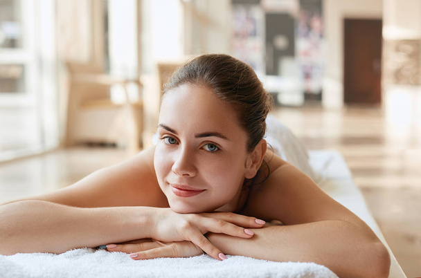 Beautiful woman  relaxing in spa salon. Spa Massage. Body care. Spa body. Cosmetology. Girl having massage in the spa salon - Foto, afbeelding