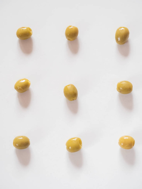 Pitted olives pattern on white background - Fotó, kép