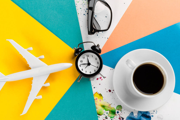 Time to travel concept. plastic plane jet toy passenger with alarm clock  - Фото, зображення