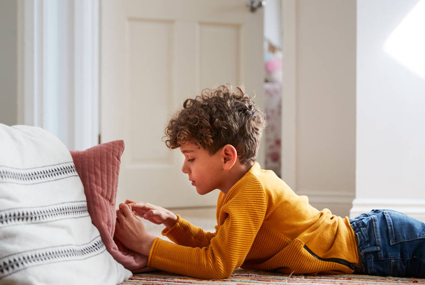 Boy Lying On Floor Of Bedroom Spending Too Much Time Using Mobile Phone - Photo, image
