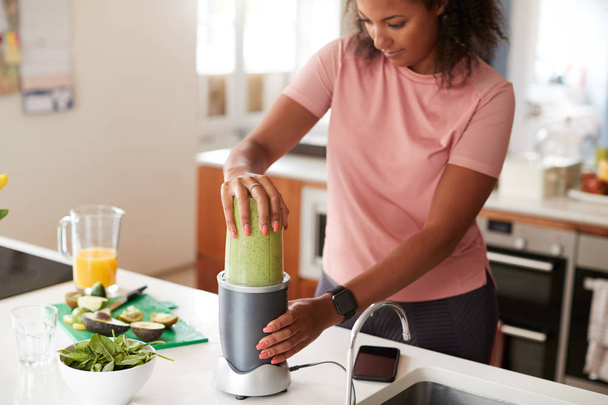 Woman Making Healthy Juice Drink With Fresh Ingredients In Electric Juicer After Exercise - Fotó, kép