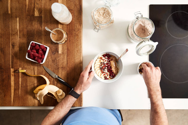 Overhead Shot Of Man Preparing Healthy Breakfast At Home After Exercise - Foto, Imagem