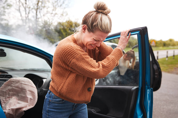 Female Motorist In Crash For Crash Insurance Fraud Getting Out Of Car - Фото, изображение