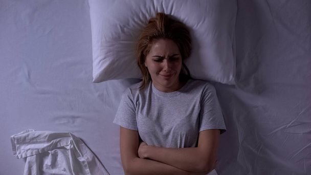 Young lady crying in bed, experiencing life difficulties, relationship crisis - Foto, immagini