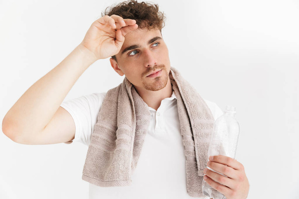 Photo closeup of tired serious man with towel looking aside and  - Φωτογραφία, εικόνα