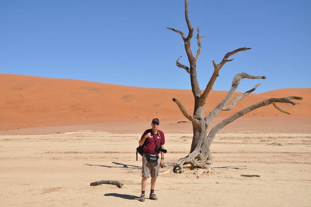 Tourist on a dune ridge with beautiful background  - Фото, изображение