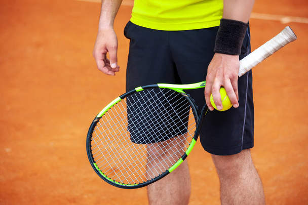 Closeup male tennis player holding racket and ball. - Fotoğraf, Görsel