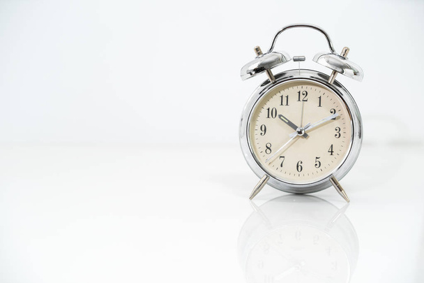 Silver alarm clock  on white  - Foto, Imagen
