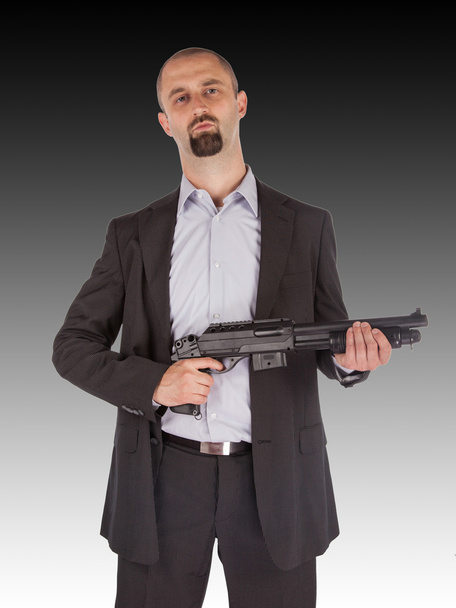 Mafia man is holding a shotgun - Фото, изображение