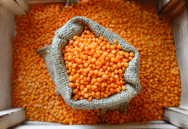 Red lentils in sack, closeup. - Photo, Image
