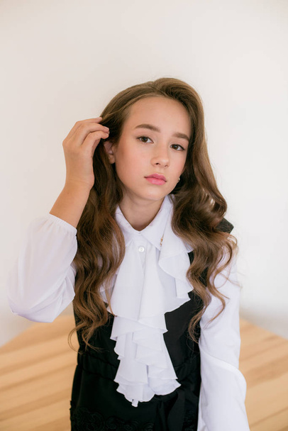 Cute girl with long  curly hair in school fashion clothes. School fashion in vintage elite style. - Fotoğraf, Görsel