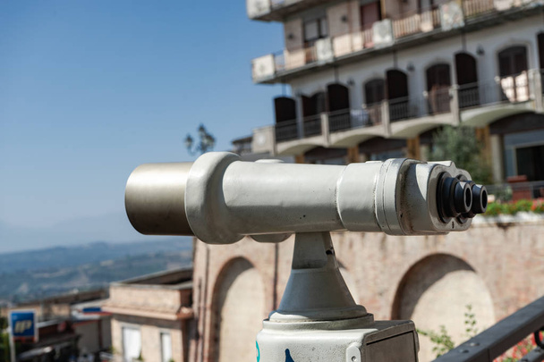 Los prismáticos miran a la ciudad con vista de la ciudad, primerísimo binocular en el punto de vista de fondo observar la visión
. - Foto, imagen