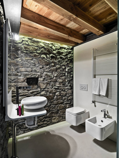 interiors shots a modern bathroom with stone wall and wooden cei - Photo, image