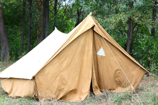Ancienne tente en toile dans un camp touristique en été sur fond d'arbres verts
 - Photo, image