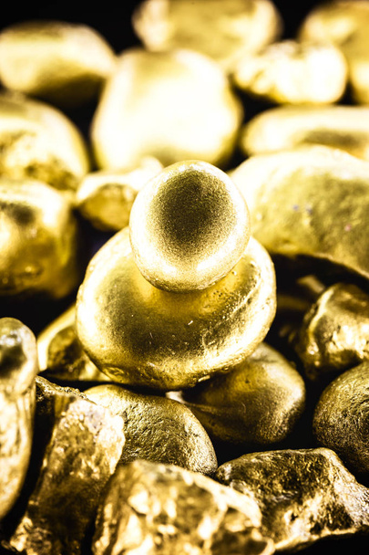gold texture, many gold nugget, stone of value. Crude gold drawn on black background. Concept of wealth or luxury. - Photo, Image