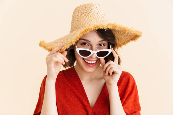 Portrait closeup of young brunette vacation woman wearing straw  - Photo, image