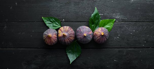 Figs on wooden background. Tropical fruits. Top view. Free copy space. - Fotoğraf, Görsel