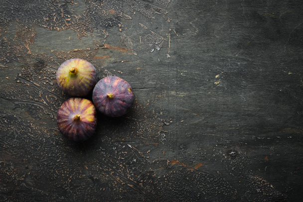 Figs on wooden background. Tropical fruits. Top view. Free copy space. - Foto, Bild