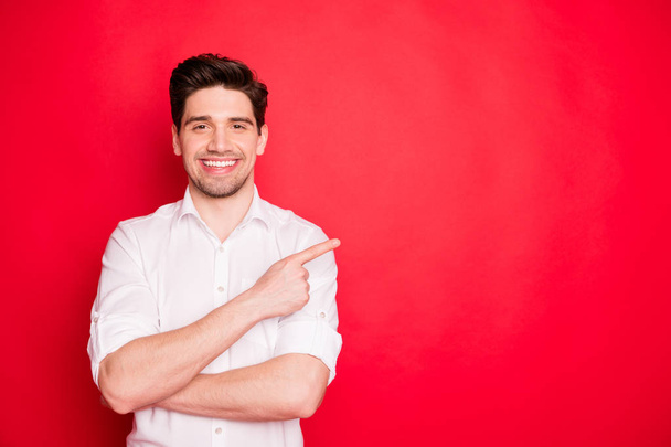 Portrait of his he nice attractive cheerful cheery content guy employee employer pointing forefinger aside ad sale discount black Friday isolated over bright vivid shine red background - Foto, Bild