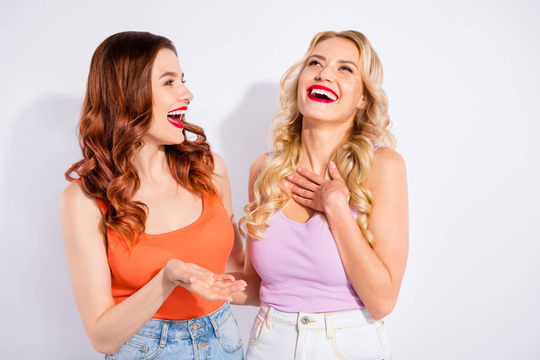 Two pretty ladies spending free time together tell humorous stories wear casual tank-tops isolated white background - Photo, image