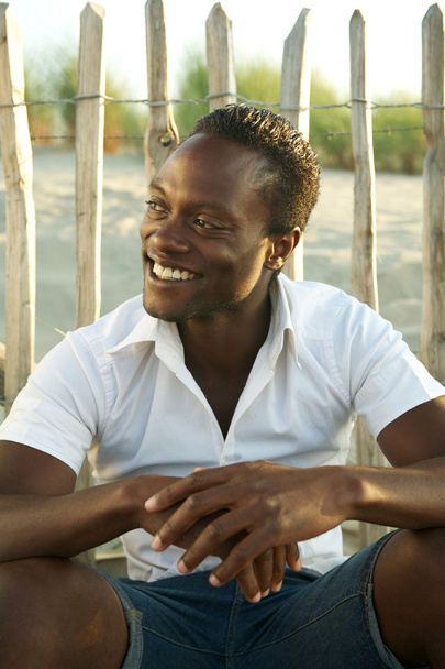 Happy black man smiling outdoors - Fotó, kép