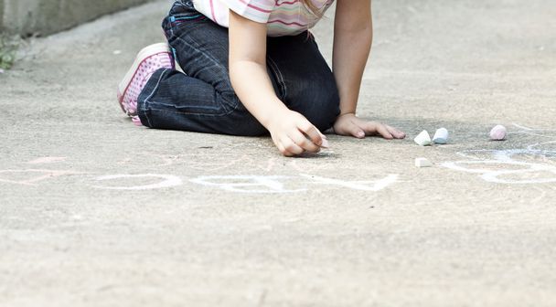 Back to school concept - Photo of girl writing with chalk on the schoolyard - Φωτογραφία, εικόνα