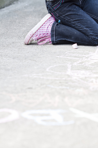 Back to school concept - Photo of girl writing with chalk on the schoolyard - Photo, image