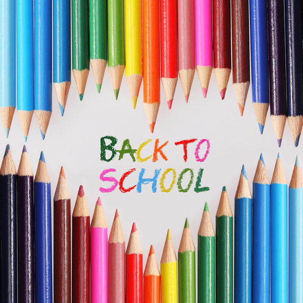 Back to school concept. Colorful pencils arranged as heart. The words 'Back to School' written in pencil in the heart shape - Fotoğraf, Görsel