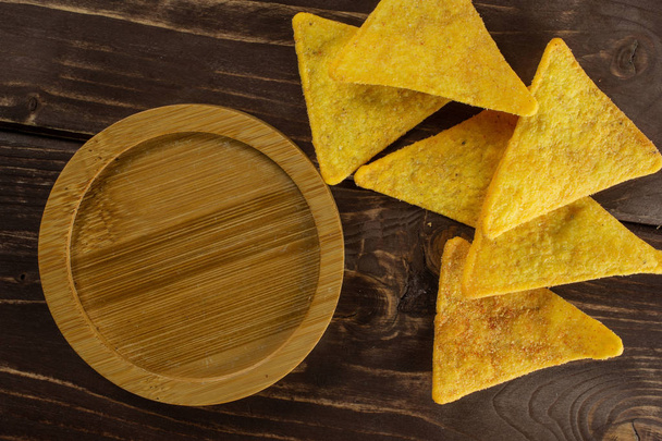 Tortilla cheese chips on brown wood - Foto, afbeelding
