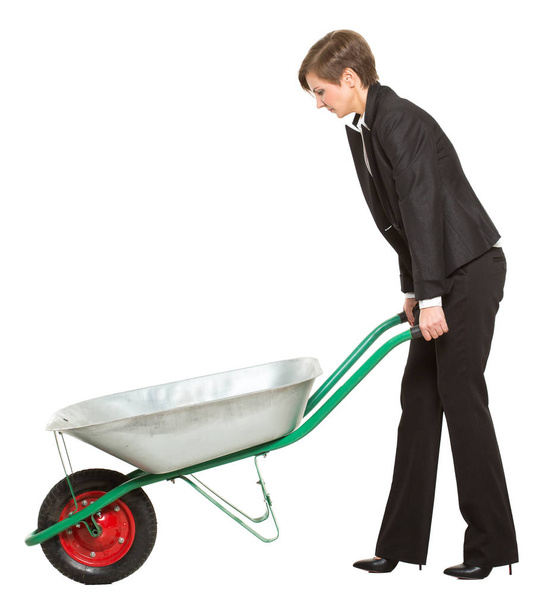 allegory. office worker, manager, tortured business woman with a wheelbarrow isolated on white background - Foto, imagen