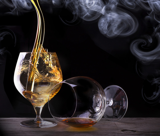 Cognac glass shrouded in a smoke - Photo, Image