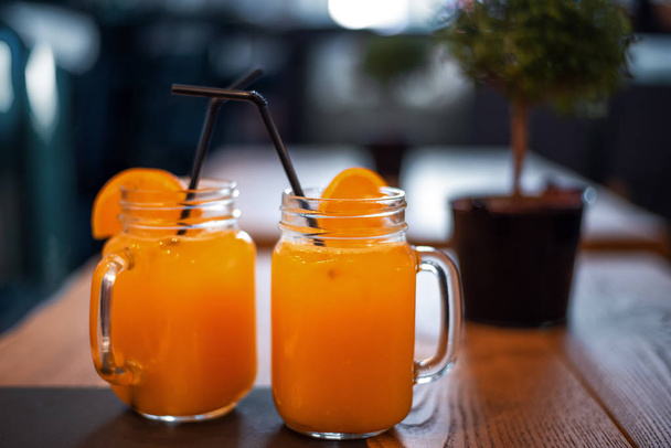 Cocktail in mug with oranges slice. Mug delicious refreshing drink with orange - Photo, Image
