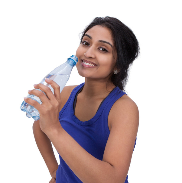 Smiling female athelte with water bottle - Photo, Image