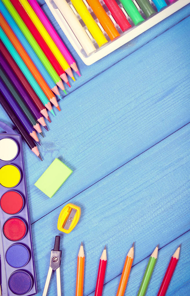 School accessories on blue boards. Back to school concept, copy space for text - 写真・画像
