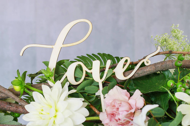 Wooden word love in front od flower background  - Photo, Image